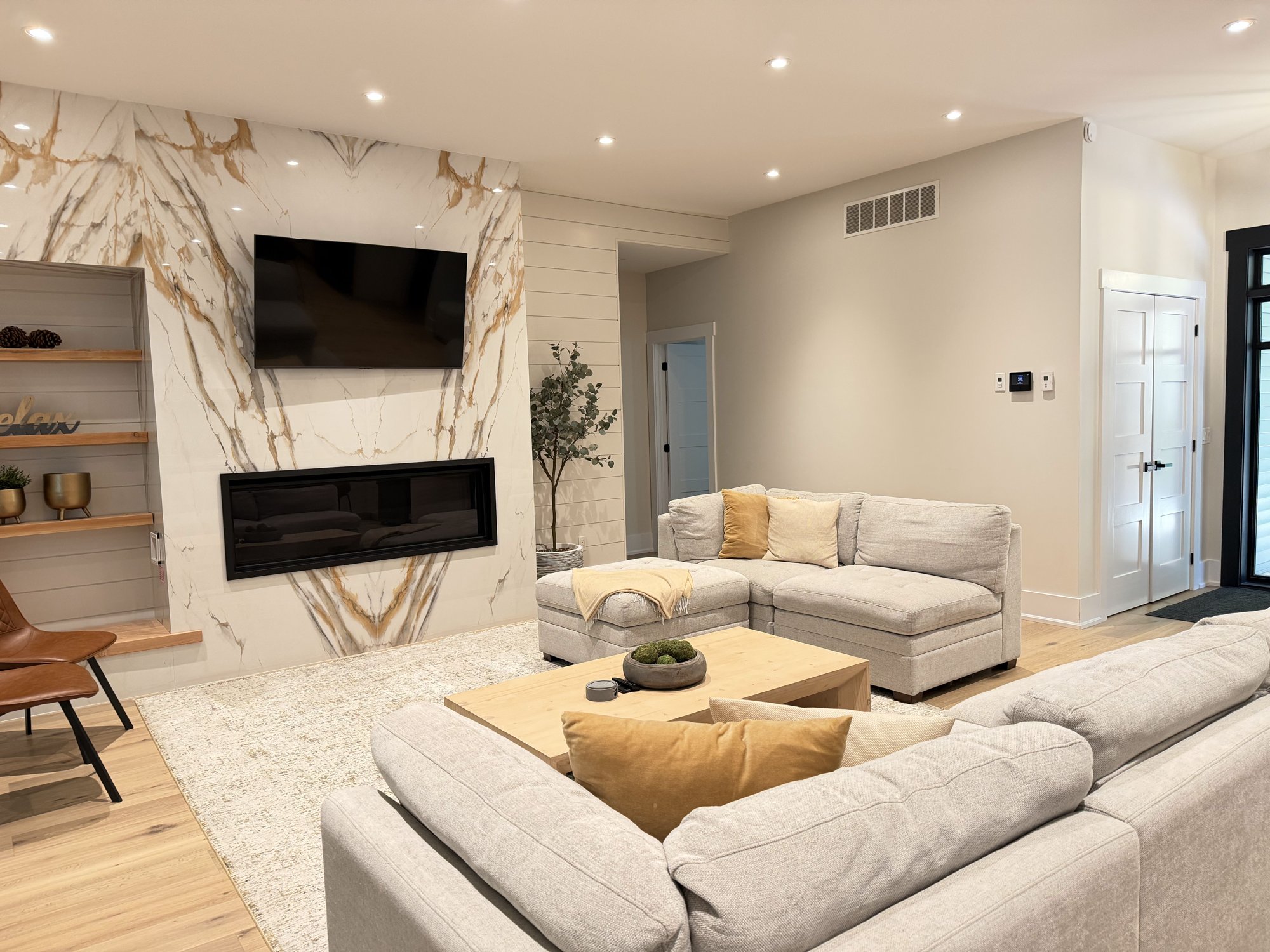 Open-concept living room with marble fireplace