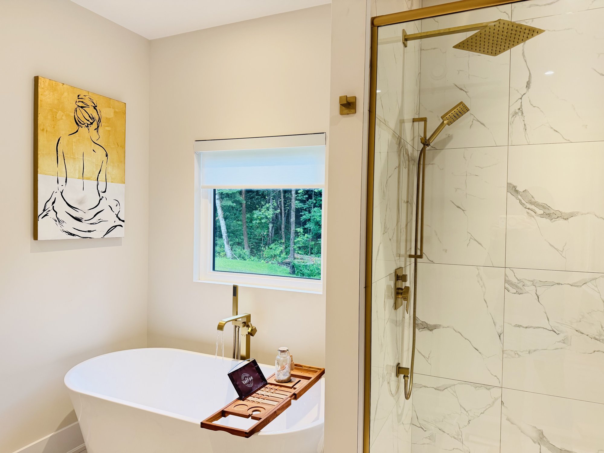Master bath with freestanding tub and gold fixtures